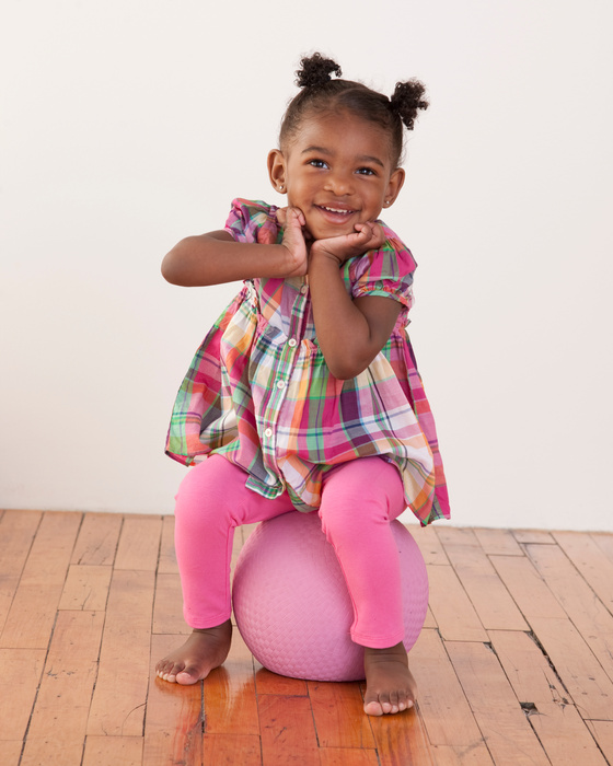 African American Toddler Girl Sitting on Ball
